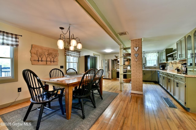 157 Mosquito Swamp Rd, Greenwich, NY 12834 - dining space featuring light wood-type flooring, a chandelier, and ornate columns