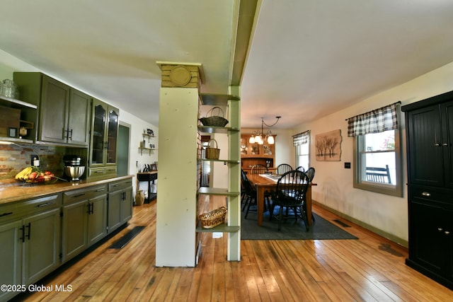 157 Mosquito Swamp Rd, Greenwich, NY 12834 - kitchen with green cabinets, open shelves, light wood-style flooring, and backsplash