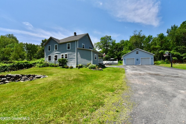 157 Mosquito Swamp Rd, Greenwich, NY 12834 - view of front facade featuring an outbuilding, a garage, and a front lawn