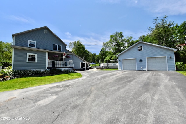 157 Mosquito Swamp Rd, Greenwich, NY 12834 - view of side of property featuring a detached garage, covered porch, an outbuilding, and a yard