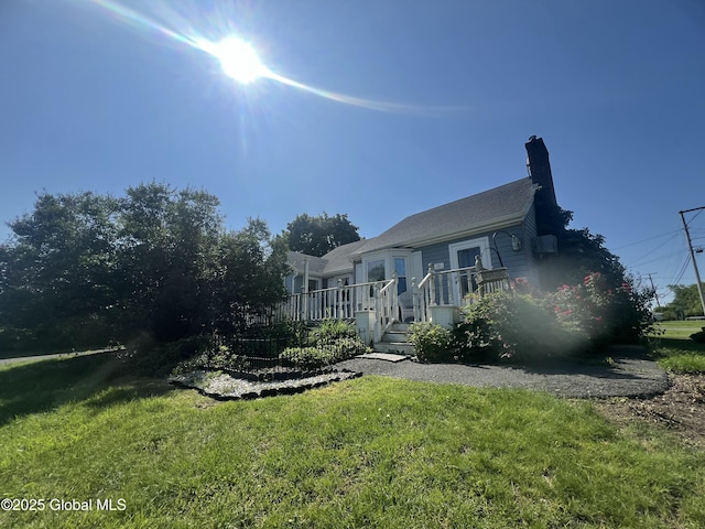 56 Wendell St, Ravena, NY 12143 - view of front facade with a front lawn, a chimney, and a deck