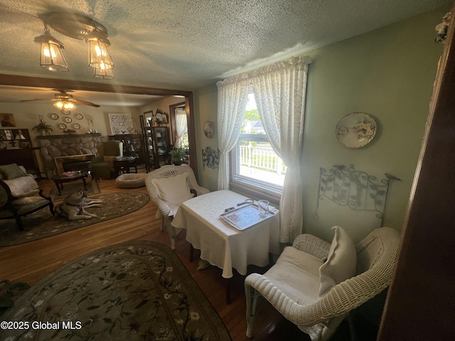 56 Wendell St, Ravena, NY 12143 - living area featuring a textured ceiling, wood finished floors, ceiling fan, and a fireplace
