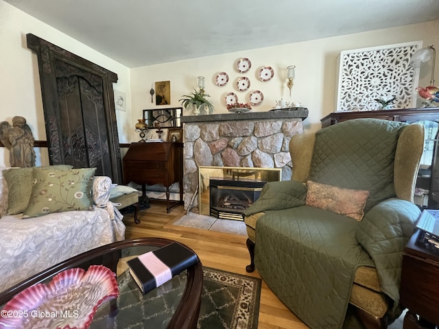 56 Wendell St, Ravena, NY 12143 - living area with a stone fireplace, wood finished floors, and baseboard heating