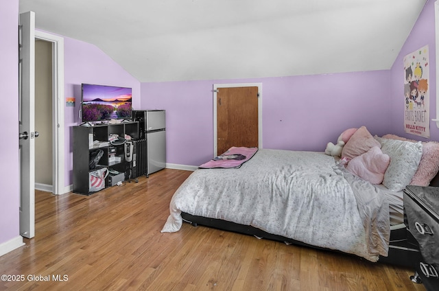 954 Obrien Ave, Rotterdam, NY 12303 - bedroom featuring lofted ceiling, freestanding refrigerator, and wood finished floors