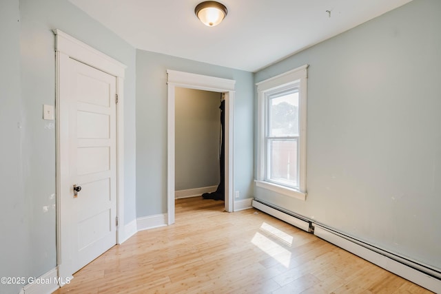 1818 4th St, Rensselaer, NY 12144 - unfurnished bedroom featuring baseboard heating and light wood-style flooring