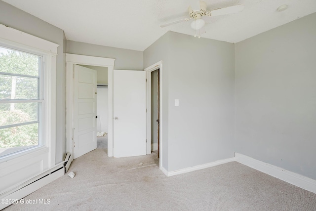 1818 4th St, Rensselaer, NY 12144 - unfurnished bedroom featuring baseboard heating, carpet flooring, and multiple windows