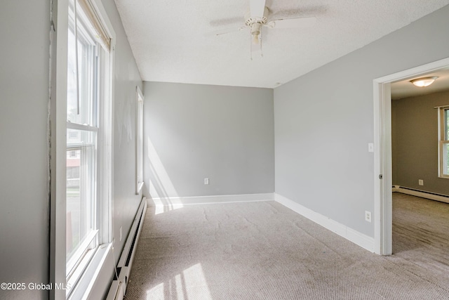 1818 4th St, Rensselaer, NY 12144 - empty room with a baseboard radiator, carpet flooring, ceiling fan, and plenty of natural light