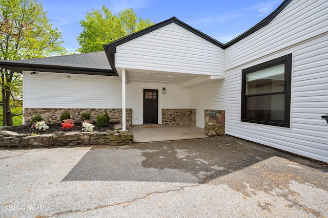 1 Wawayanda Pl, Middletown, NY 10940 - property entrance featuring stone siding, a shingled roof, and a patio area