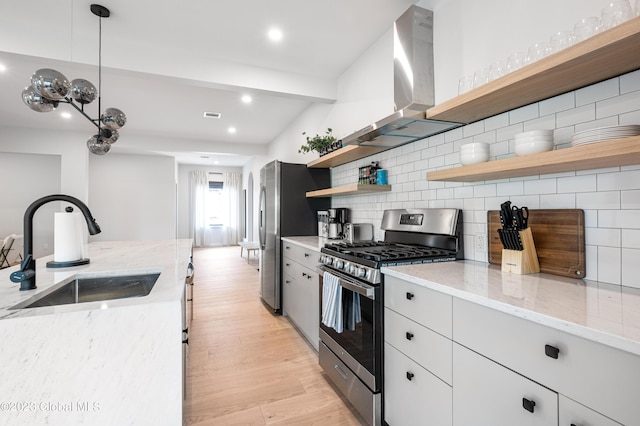 1 Wawayanda Pl, Middletown, NY 10940 - kitchen with stainless steel appliances, wall chimney range hood, open shelves, light wood-style floors, and decorative backsplash
