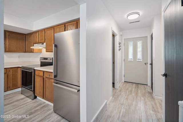 24 Esplande St, Bethlehem, NY 12158 - kitchen with appliances with stainless steel finishes, under cabinet range hood, brown cabinetry, and light wood-style floors