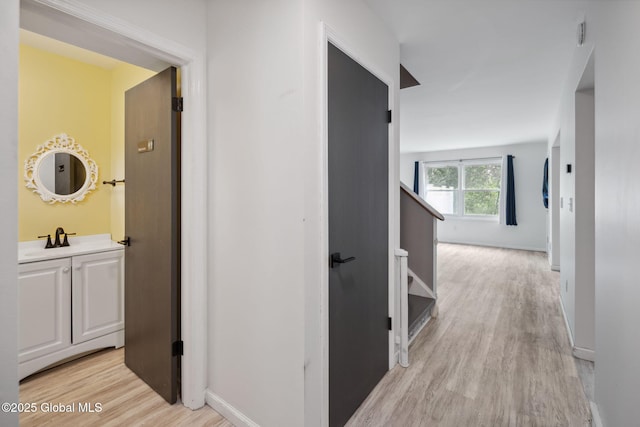 24 Esplande St, Bethlehem, NY 12158 - corridor featuring light wood-style flooring and a sink