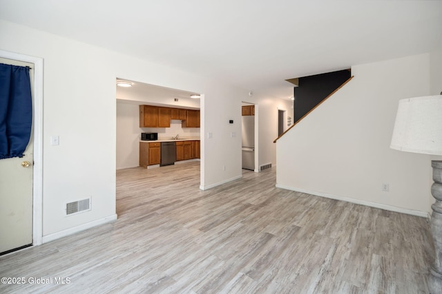 24 Esplande St, Bethlehem, NY 12158 - unfurnished living room with light wood-type flooring and stairway