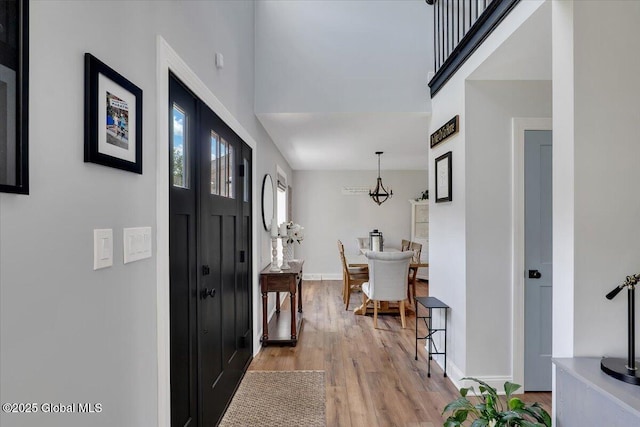 139 Country Walk Rd, Rotterdam, NY 12306 - foyer entrance with light wood-type flooring and a chandelier