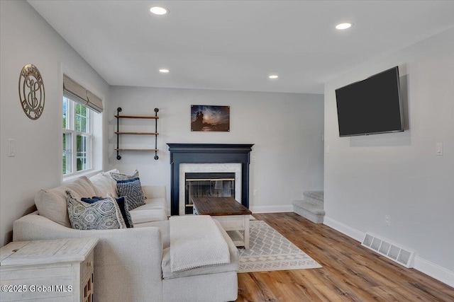 139 Country Walk Rd, Rotterdam, NY 12306 - living room with recessed lighting, wood finished floors, a premium fireplace, and stairway