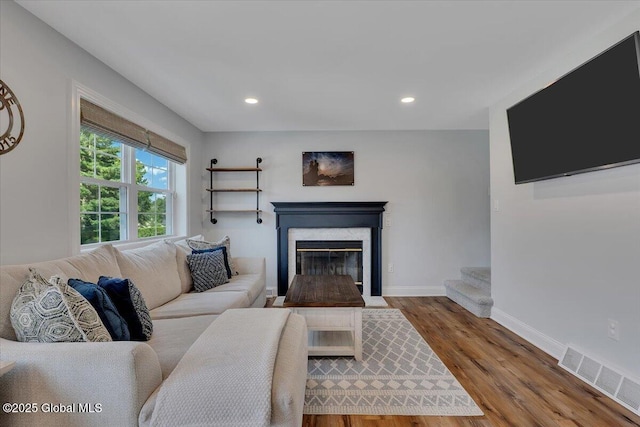 139 Country Walk Rd, Rotterdam, NY 12306 - living area with wood finished floors, recessed lighting, and a premium fireplace