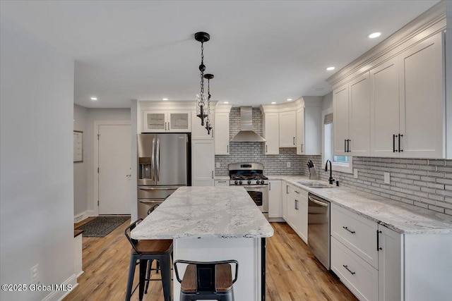 139 Country Walk Rd, Rotterdam, NY 12306 - kitchen with appliances with stainless steel finishes, wall chimney exhaust hood, decorative backsplash, white cabinetry, and recessed lighting