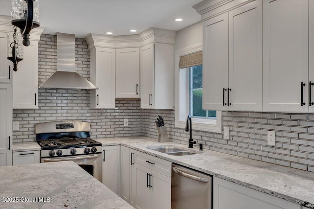 139 Country Walk Rd, Rotterdam, NY 12306 - kitchen with wall chimney range hood, stainless steel appliances, tasteful backsplash, and white cabinets