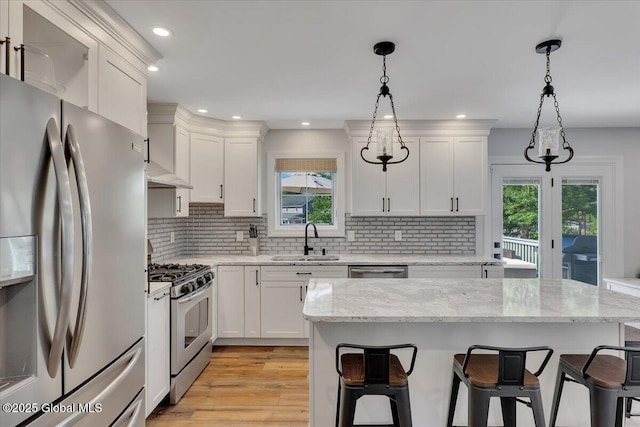 139 Country Walk Rd, Rotterdam, NY 12306 - kitchen with appliances with stainless steel finishes, a kitchen bar, white cabinets, tasteful backsplash, and recessed lighting
