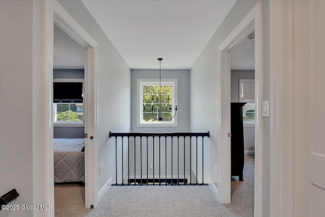 139 Country Walk Rd, Rotterdam, NY 12306 - hallway featuring carpet flooring, a chandelier, and plenty of natural light