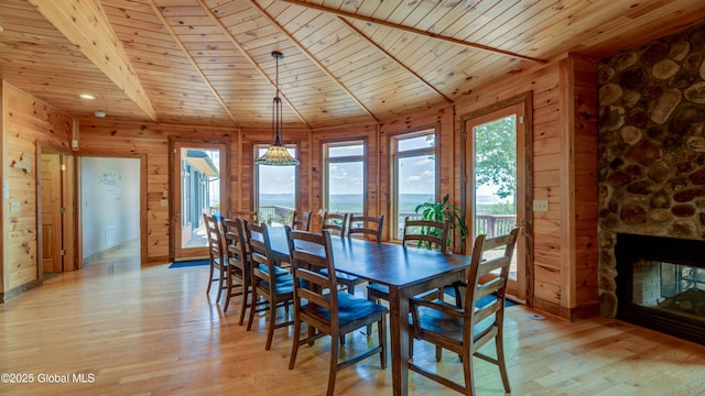 102 Taylor Ct, Mayfield, NY 12117 - dining area featuring wood ceiling, wood walls, light wood finished floors, and a fireplace