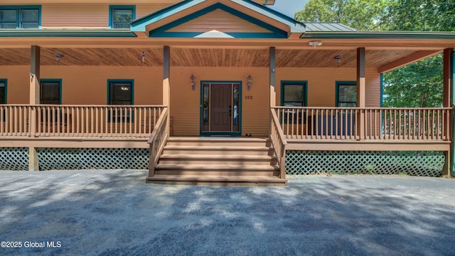 102 Taylor Ct, Mayfield, NY 12117 - view of front facade featuring covered porch and a metal roof