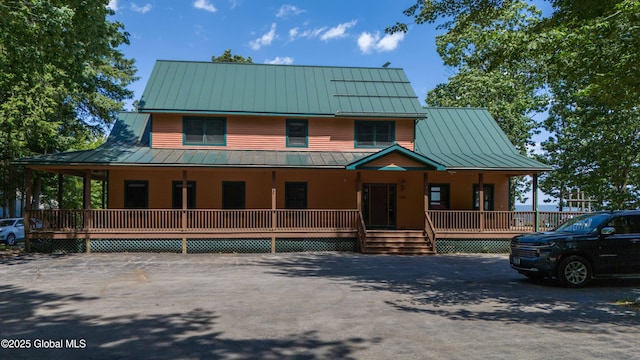 102 Taylor Ct, Mayfield, NY 12117 - farmhouse-style home featuring a standing seam roof, a porch, and a metal roof