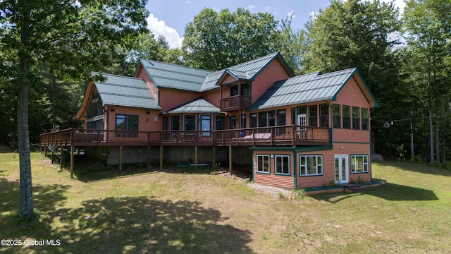 102 Taylor Ct, Mayfield, NY 12117 - back of property with a standing seam roof, a wooden deck, a metal roof, and a yard