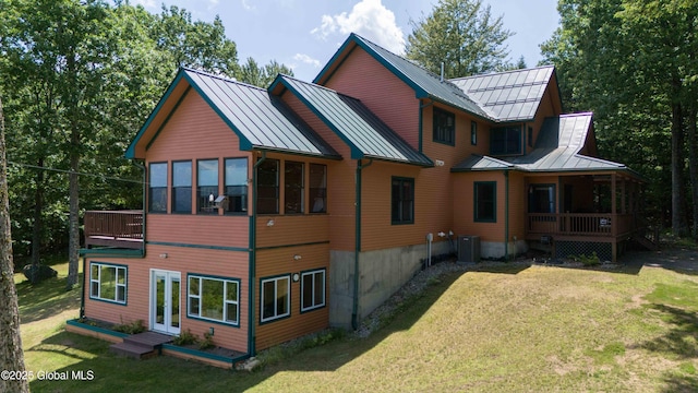 102 Taylor Ct, Mayfield, NY 12117 - back of property with a standing seam roof, a lawn, covered porch, and a metal roof