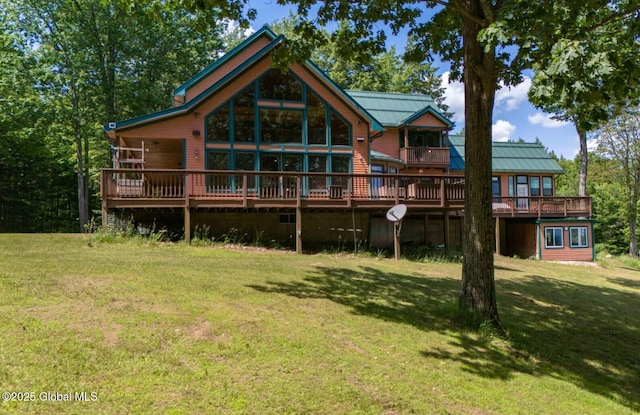 102 Taylor Ct, Mayfield, NY 12117 - back of property with a lawn, a standing seam roof, a metal roof, and a wooden deck