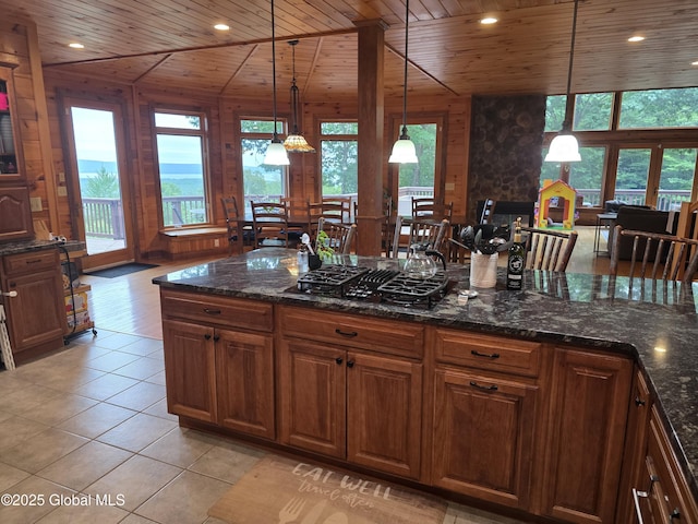 102 Taylor Ct, Mayfield, NY 12117 - kitchen with wood ceiling, black gas stovetop, light tile patterned floors, hanging light fixtures, and brown cabinets