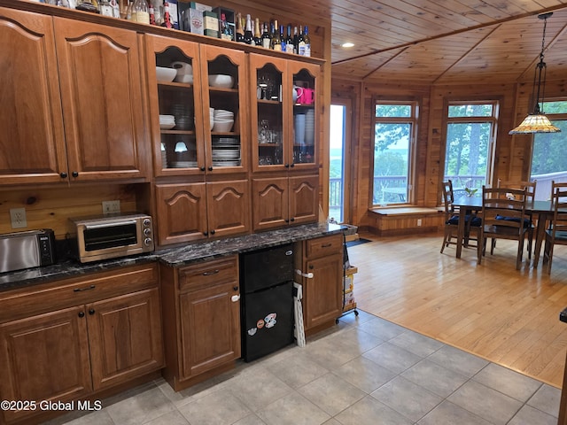 102 Taylor Ct, Mayfield, NY 12117 - kitchen with glass insert cabinets, wooden ceiling, dark stone countertops, hanging light fixtures, and brown cabinets