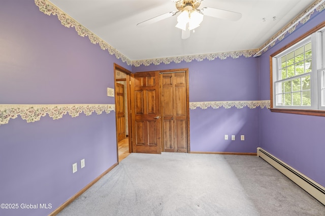 654 Birchwood Dr, Princetown, NY 12056 - unfurnished bedroom featuring baseboard heating, carpet, and a ceiling fan