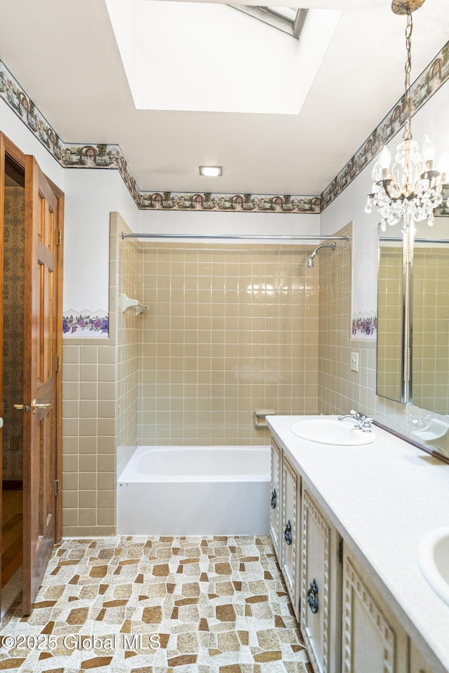 654 Birchwood Dr, Princetown, NY 12056 - bathroom featuring a skylight, tile walls, washtub / shower combination, double vanity, and a chandelier
