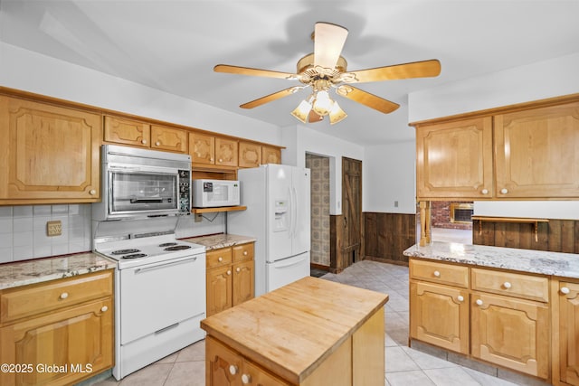 654 Birchwood Dr, Princetown, NY 12056 - kitchen with white appliances, ceiling fan, light tile patterned flooring, backsplash, and light stone countertops