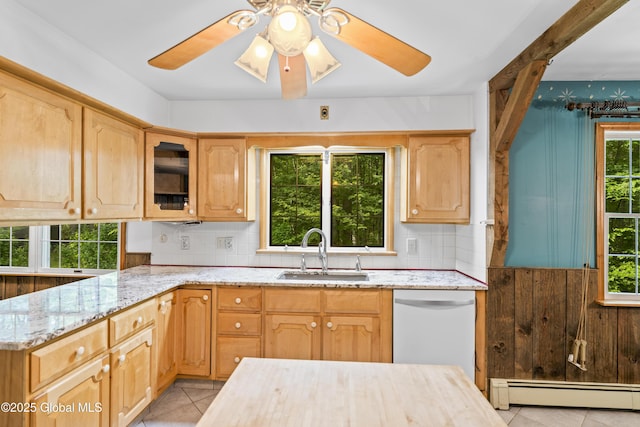 654 Birchwood Dr, Princetown, NY 12056 - kitchen with a baseboard radiator, white dishwasher, light stone counters, light tile patterned floors, and tasteful backsplash