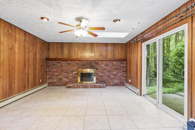 654 Birchwood Dr, Princetown, NY 12056 - unfurnished living room with baseboard heating, wooden walls, a fireplace, ceiling fan, and a textured ceiling
