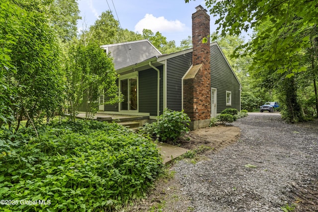 654 Birchwood Dr, Princetown, NY 12056 - view of property exterior featuring a chimney and gravel driveway