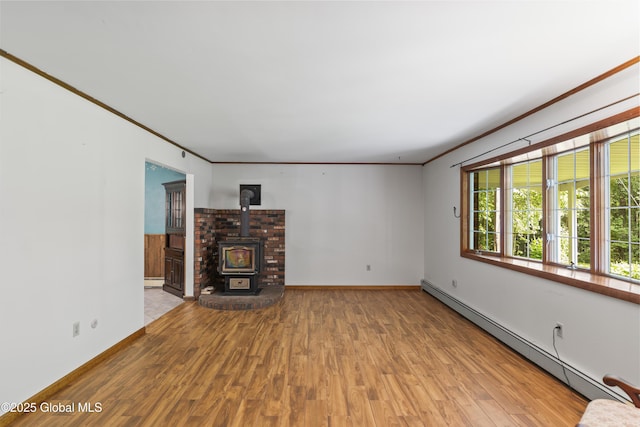 654 Birchwood Dr, Princetown, NY 12056 - unfurnished living room featuring a baseboard radiator, wood finished floors, crown molding, a wood stove, and a baseboard heating unit