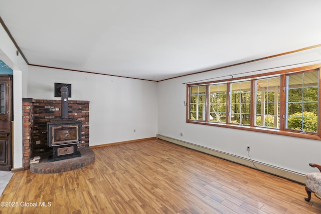 654 Birchwood Dr, Princetown, NY 12056 - unfurnished living room with a baseboard heating unit, wood finished floors, a wood stove, and ornamental molding