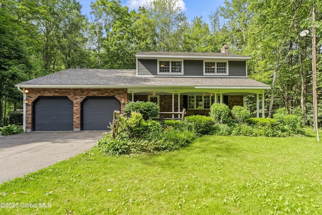 654 Birchwood Dr, Princetown, NY 12056 - traditional-style house featuring a chimney, an attached garage, a front lawn, and driveway