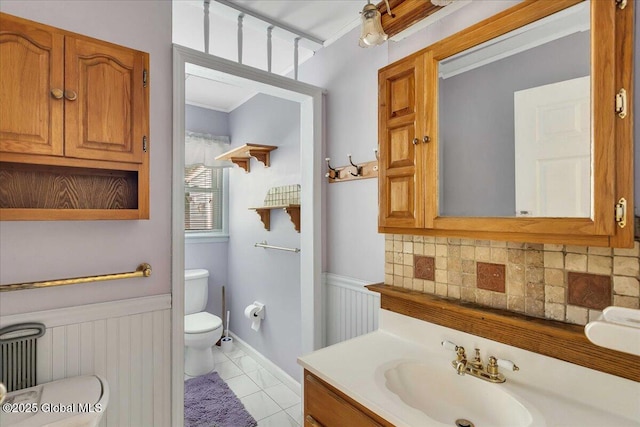 273 Pinehurst Ave, East Greenbush, NY 12144 - bathroom featuring vanity, wainscoting, tile patterned flooring, and decorative backsplash