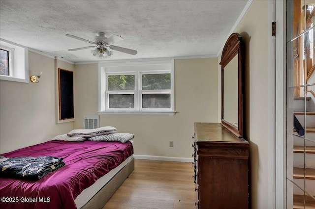 273 Pinehurst Ave, East Greenbush, NY 12144 - bedroom with wood finished floors, a textured ceiling, ornamental molding, and a ceiling fan