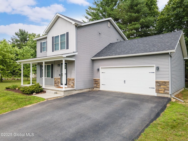 5 Heather Ln, Corinth, NY 12822 - craftsman-style house featuring stone siding, a porch, a garage, and asphalt driveway