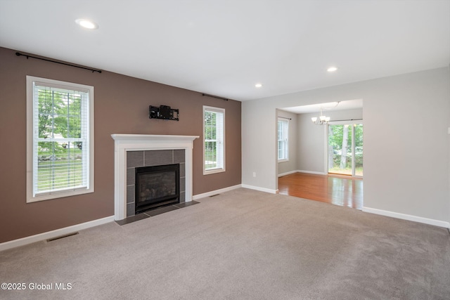 5 Heather Ln, Corinth, NY 12822 - unfurnished living room featuring carpet floors, a chandelier, a tile fireplace, and recessed lighting