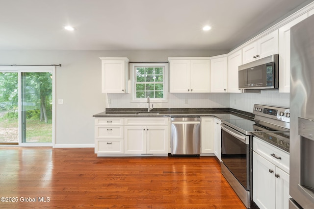 5 Heather Ln, Corinth, NY 12822 - kitchen with appliances with stainless steel finishes, tasteful backsplash, white cabinetry, recessed lighting, and dark wood-type flooring