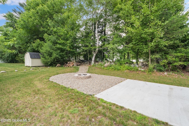5 Heather Ln, Corinth, NY 12822 - view of grassy yard with a storage unit, an outdoor fire pit, and a patio area