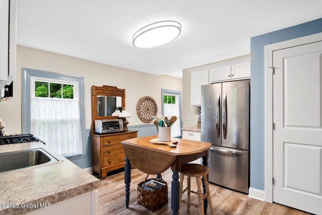 4 Mitchell Ave, Cambridge, NY 12816 - kitchen featuring freestanding refrigerator, stainless steel refrigerator, light countertops, light wood-type flooring, and white cabinets