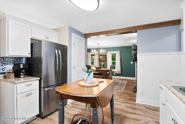 4 Mitchell Ave, Cambridge, NY 12816 - kitchen with freestanding refrigerator, a chandelier, light wood-style flooring, white cabinetry, and light countertops