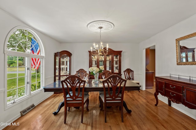 658 Salvia Ln, Guilderland, NY 12303 - dining area featuring a chandelier, light wood-type flooring, and healthy amount of natural light