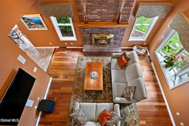 658 Salvia Ln, Guilderland, NY 12303 - living room featuring wood finished floors, a fireplace, and a high ceiling